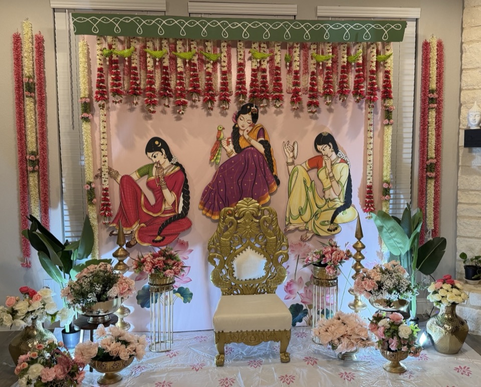 A pelli kuthuru stage with painted saree ladies, parrot garlands and a carved gold chair